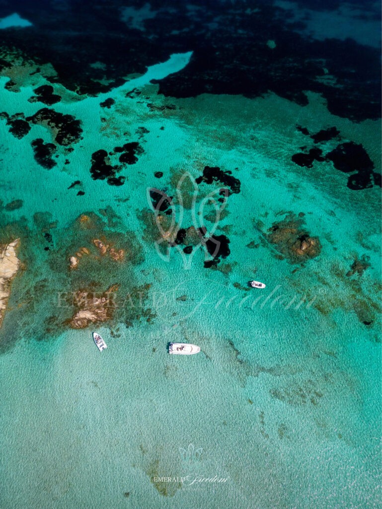 Boat cruising through the waters of the La Maddalena Archipelago during a private boat tour