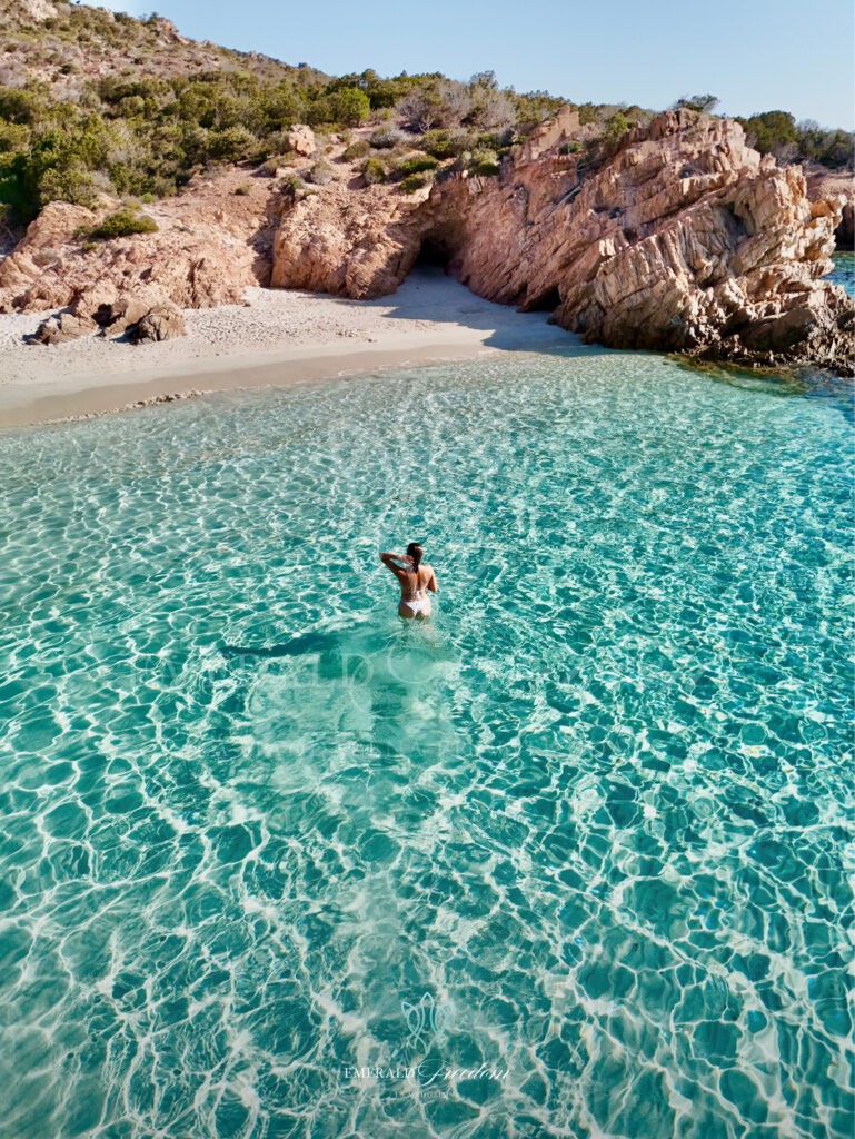 Girl swimming in clear turquoise water during a private boat tour in La Maddalena